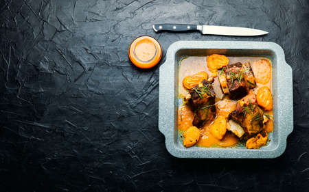 Beef ribs stewed in apricots. Braised meat with fruit sauce.Copy spaceの写真素材