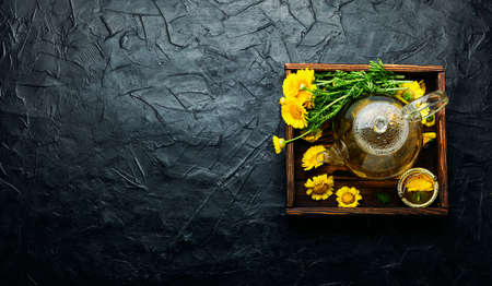Glass teapot with chrysanthemum flower tea. Flower tea. Herbal medicine. Herbal medicine and...
