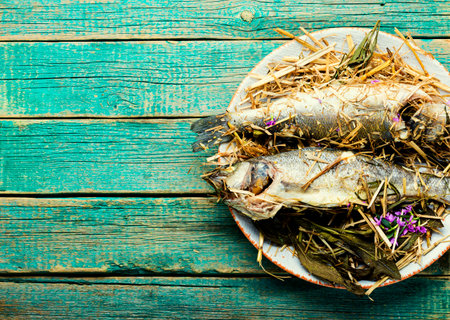 Fish baked in spicy herbs and hay.Roasted sea bass.Copy spaceの写真素材