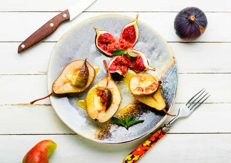 Baked pear halves with figs.Autumn vegan dessert