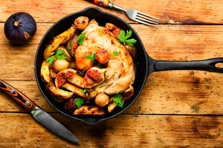 Chicken meat roasted with potatoes and figs. Meat cooked with figs.の写真素材