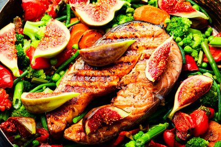 Fried salmon steak with figs. Baked trout, food backgroundの写真素材
