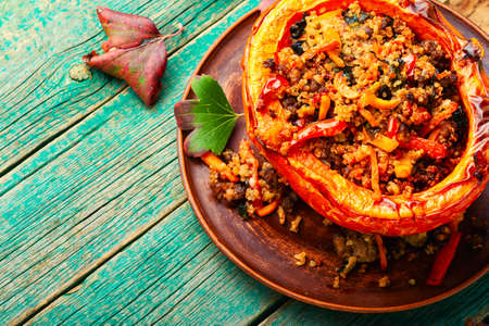 Pumpkin halves stuffed with minced meat,vegetables and quinoa.Autumn stewed pumpkin hokkaidoの写真素材