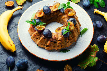 Delicious homemade banana plum cake. Sweet summer dessert