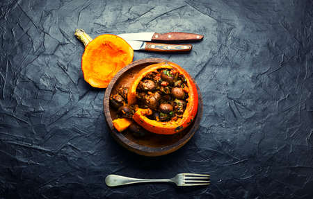 Baked pumpkin stuffed with mushrooms and rice. Traditional autumn food.Copy spaceの写真素材