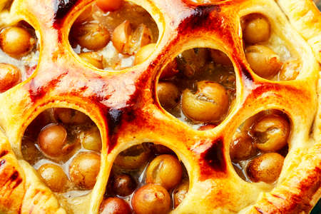 Homemade autumn pies with pear, apple, grapes and plum.Close upの写真素材