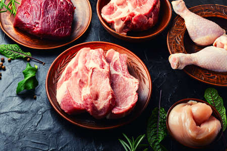 Fresh piece of meat on kitchen table.Veal, pork and chicken for cooking.