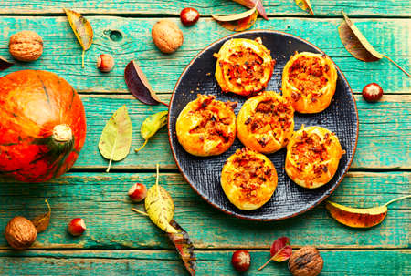 Homemade delicious buns stuffed with autumn pumpkin and meatの写真素材