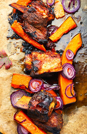 Beef ribs BBQ.Baked beef meat with slices of pumpkinの写真素材