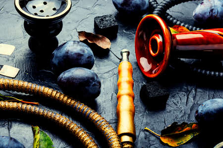 Smoking hookah with plum flavored tobacco.Fruit shisha
