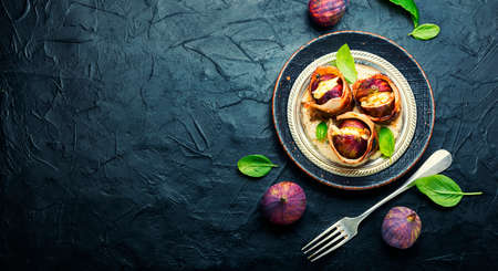 Fig with goat cheese baked with bacon and yogurt sauce.Copy spaceの写真素材