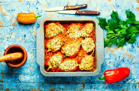 Sweet peppers stuffed with turkey, herbs and rice. Sweet peppers baked with satsiki sauce in baking dishの写真素材