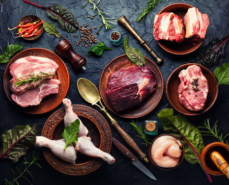 Fresh piece of meat on kitchen table.Veal, pork and chicken for cooking.の写真素材