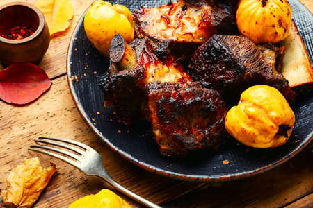 Appetizing beef ribs grilled with autumn quince.