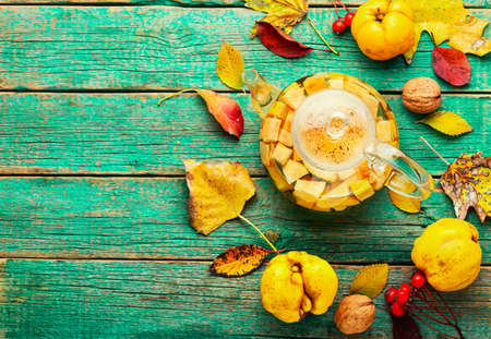 Tea made from apples and quince on an autumn background.Copy space