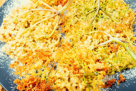 Fried elderflower in batter with powdered sugar.Food backgroundの写真素材