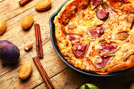 Delicious omelet with figs and almonds.Healthy breakfast,wooden surfaceの写真素材