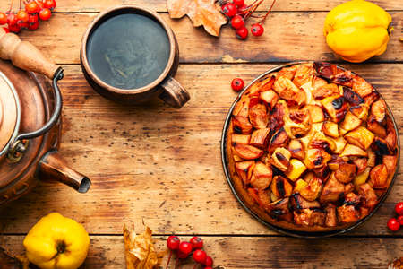 Delicious autumn quince pie. Autumn sweet on rustic wooden tableの写真素材