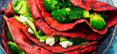Delicious beetroot pancakes with broccoli and cucumber. Vegetarian foodの写真素材