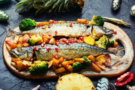 Roasted mackerel fish with pineapple for Christmas table.の写真素材