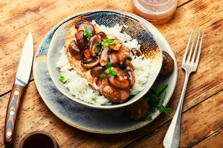 Stewed chicken breast with marsala mushroom gravy and rice.の写真素材