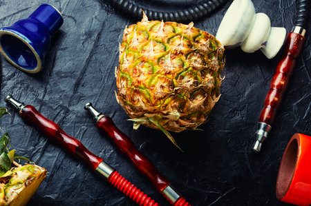 Smoking hookah with pineapple flavored tobacco. Tasty kalianの写真素材