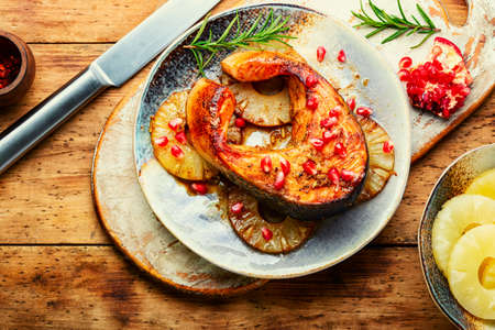Delicious grilled trout or salmon steak on pineapple.の写真素材