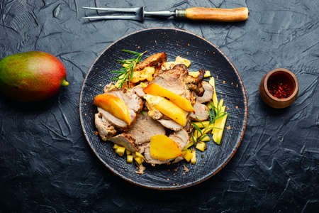 Delicious grilled meat with mango and cheese.の写真素材