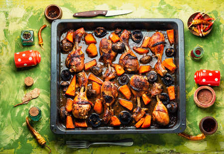 Chicken marinated meat in soy ginger sauce. Chicken legs fried with pumpkin and mushrooms.の写真素材