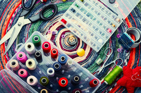 Threads, needles, buttons, scissors and seamstress tools. Sewing set for handicraft