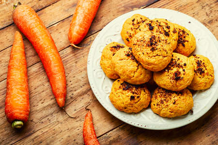 Homemade dietary carrot cookies, sweet pastries on wooden tableの写真素材