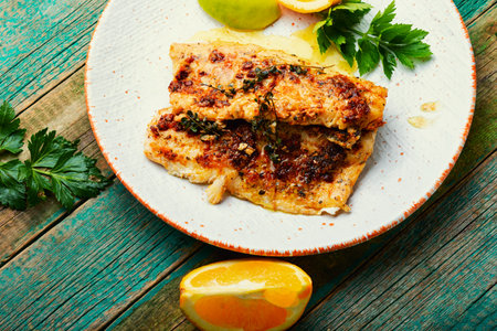 Fish fillet fried in orange oil, fish dish