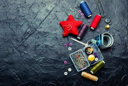 Sew threads, set needles, buttons and seamstress tools. Sewing accessories. Space for text