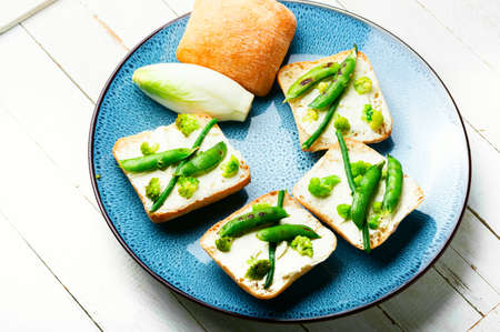 Fresh vegetable bruschetta with cabbage and green peas.Healthy foodの写真素材