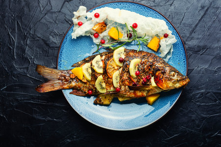 Baked fish carp with fruits, berries and spices. Healthy eating