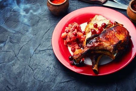 Delicious roast pork on the bone and apple sauce.の写真素材