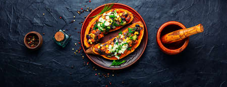 Tasty batata halves baked with vegetables and cottage cheese. Sweet potatoの写真素材