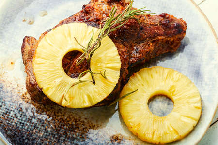 Delicious beef entrecote baked with pineapple. Tasty grilled meat.の写真素材