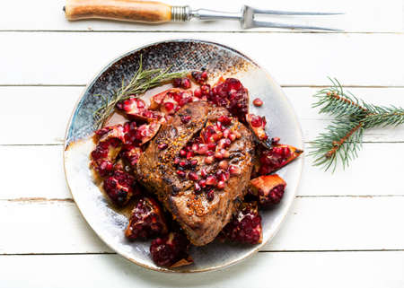 Delicious piece of meat fried with pomegranate.の写真素材