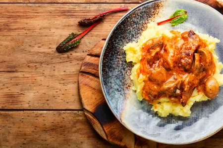 Appetizing beef stroganoff meat. Meat with mushrooms and mashed potatoesの写真素材