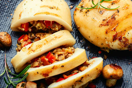 Fried squid stuffed with mushrooms and sweet peppers. Close up