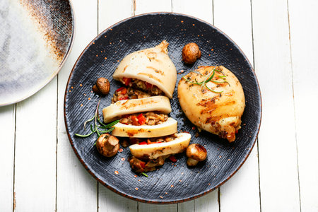 Fried squid stuffed with mushrooms and sweet peppers.の写真素材