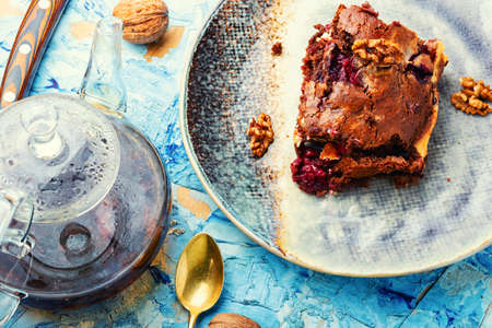 Chocolate cupcake or pie with cherries and nuts. Sweet dessert and teaの写真素材