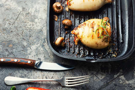 Fried squid stuffed with mushrooms on grill panの写真素材