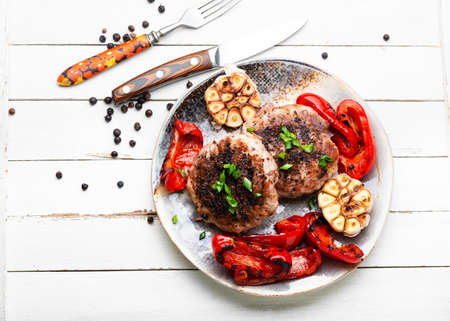 Grilled beef steak, beef and pork with spices. Fried meat in bacon.