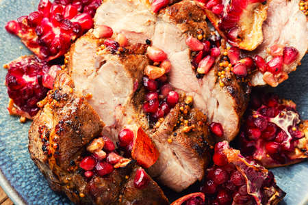 Delicious piece of meat fried with pomegranate. Close upの写真素材