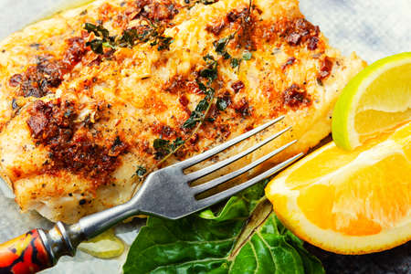 Fish fillet fried in orange oil, fish dish
