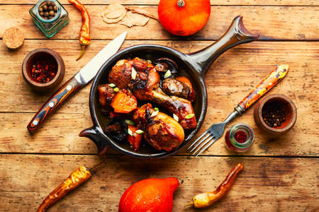 Roasted chicken legs with pumpkin and mushrooms. Autumn meat recipeの写真素材