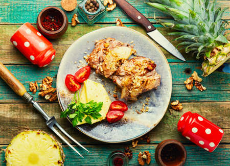 Delicious piece of pork roasted with cheese and pineappleの写真素材