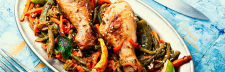 Delicious chicken legs grilled with asparagus beans and carrots.の写真素材